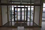 Sistema di porte scorrevoli con telaio in alluminio all'ingresso di un edificio.